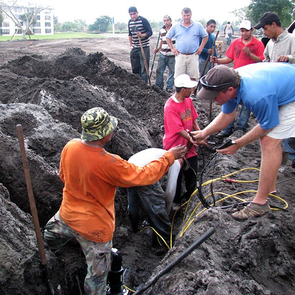 Golf course construction - installng 2-wire decoder system.